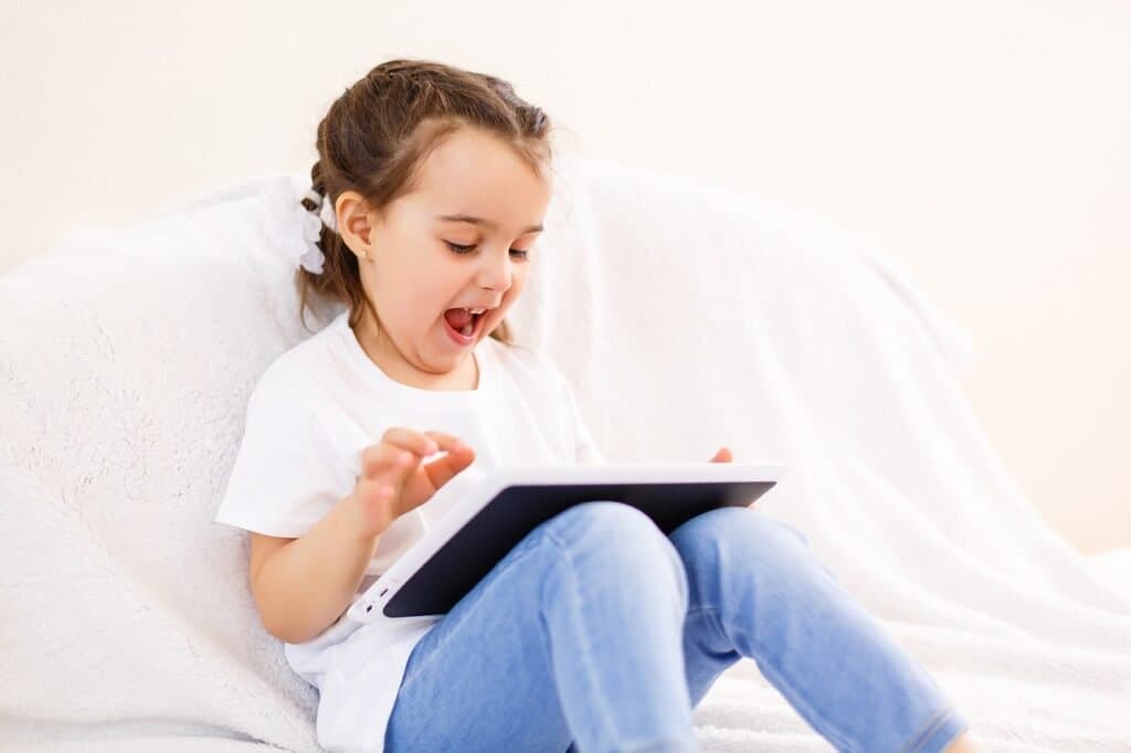 Young student using a tablet for educational screen time, demonstrating positive screen time guidelines for South African homeschooling families.