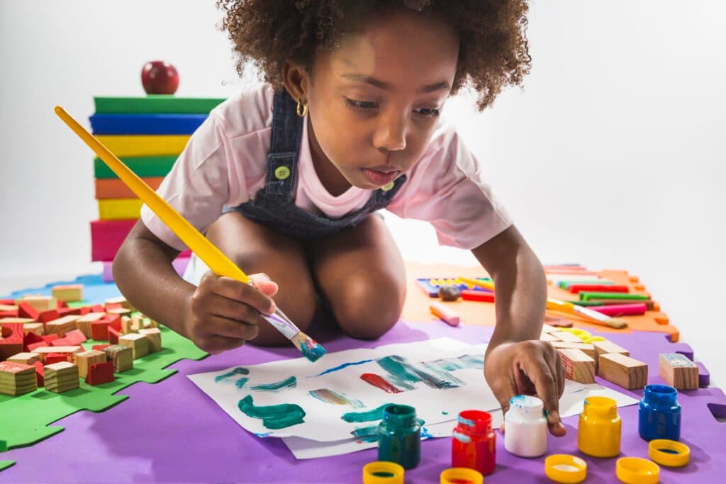 Young-child-doing-arts-and-crafts-illustrating-right-brain-development-activities-for-preschoolers-in-South-Africa