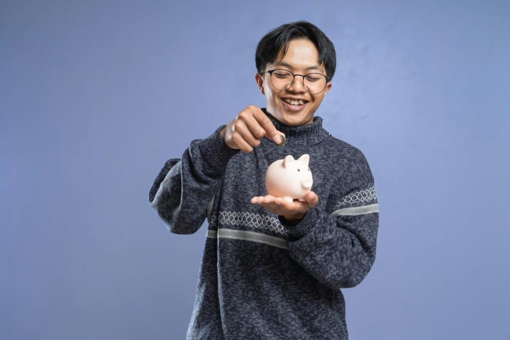 Child-learning-financial-literacy-for-kids-by-saving-money-in-a-piggy-bank-relevant-for-South-Africa-homeschooling-finance
